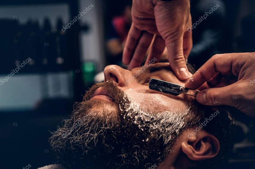 Barber rasiert den Halsbereich mit Schaum und Messer aus